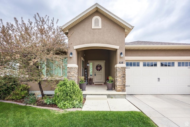 518 N 1980 E, Spanish Fork, UT 84660 - doorway to property with stucco siding, a garage, stone siding, and concrete driveway