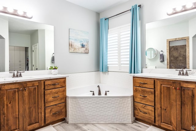 518 N 1980 E, Spanish Fork, UT 84660 - full bathroom featuring a garden tub, two vanities, a sink, and wood finished floors
