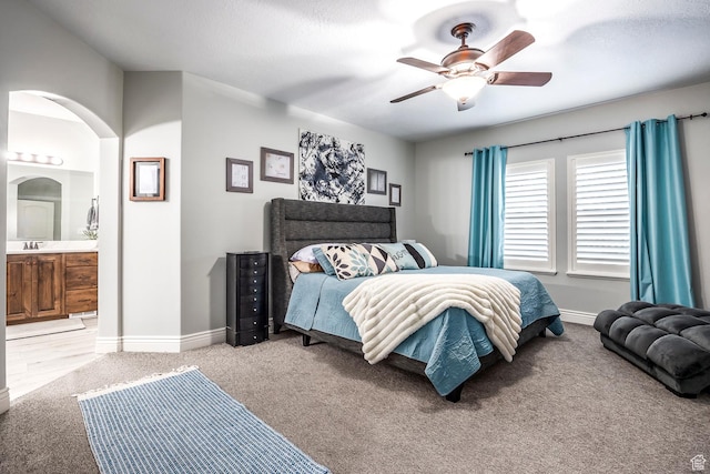 518 N 1980 E, Spanish Fork, UT 84660 - bedroom with arched walkways, baseboards, ensuite bath, and light colored carpet