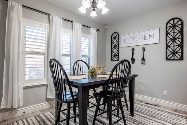 518 N 1980 E, Spanish Fork, UT 84660 - dining room with baseboards, wood finished floors, healthy amount of natural light, and a chandelier