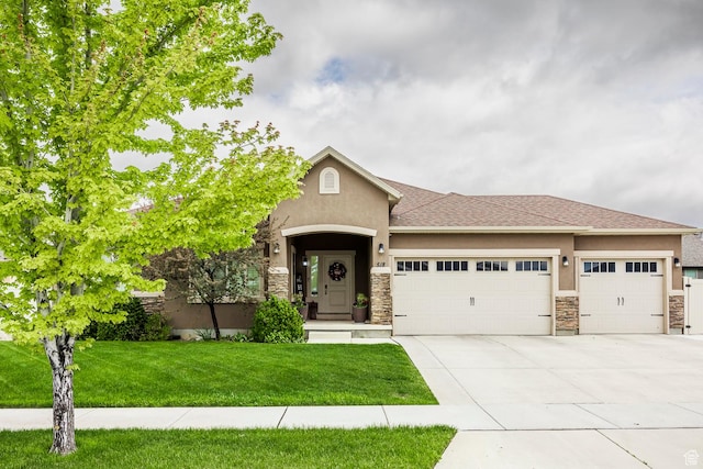518 N 1980 E, Spanish Fork, UT 84660 - view of front facade with an attached garage, stucco siding, stone siding, concrete driveway, and a front yard