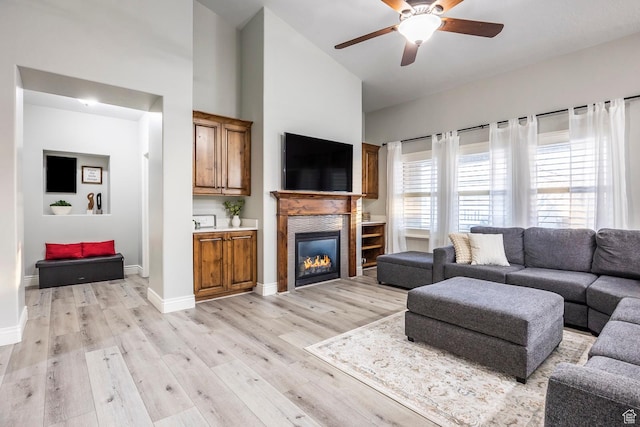 518 N 1980 E, Spanish Fork, UT 84660 - living room with baseboards, a stone fireplace, ceiling fan, high vaulted ceiling, and light wood-type flooring