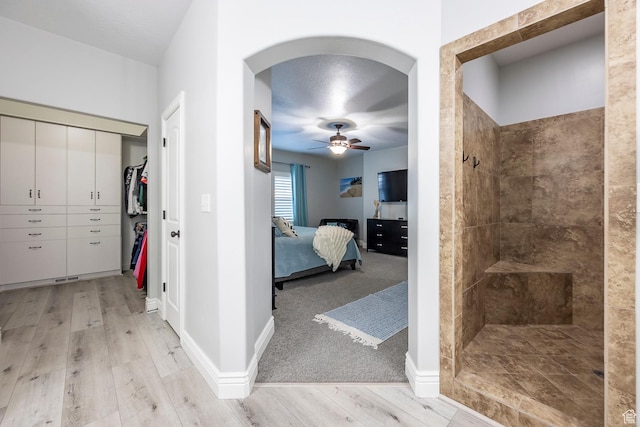 518 N 1980 E, Spanish Fork, UT 84660 - bathroom with baseboards, ceiling fan, a tile shower, connected bathroom, and wood finished floors