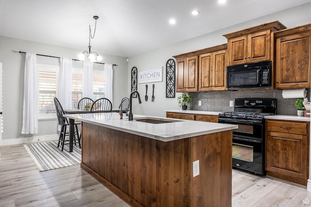 518 N 1980 E, Spanish Fork, UT 84660 - kitchen featuring black appliances, an inviting chandelier, light wood-type flooring, and a sink