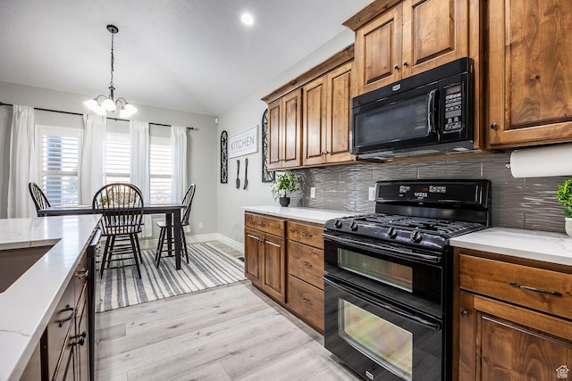 518 N 1980 E, Spanish Fork, UT 84660 - kitchen with a chandelier, brown cabinetry, black appliances, and light wood-style floors