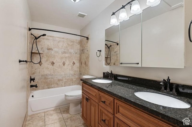 full bathroom featuring vanity, tile patterned floors, toilet, and tiled shower / bath