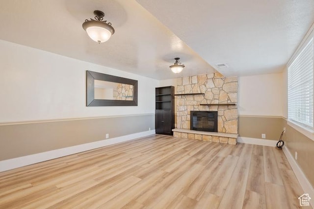 unfurnished living room featuring a fireplace and hardwood / wood-style floors