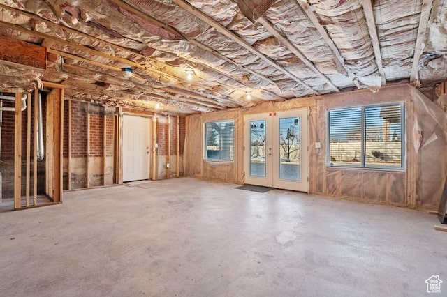 misc room with concrete flooring and french doors