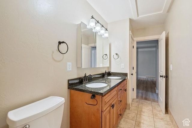 bathroom with vanity, tile patterned flooring, and toilet