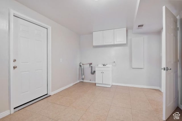 laundry area with sink and light tile patterned floors