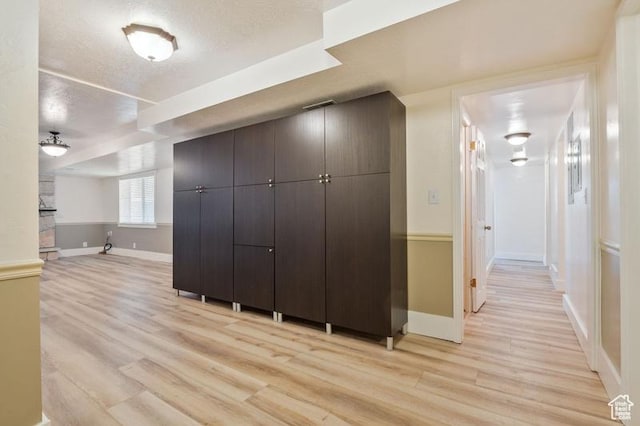 interior space with light hardwood / wood-style floors and a textured ceiling
