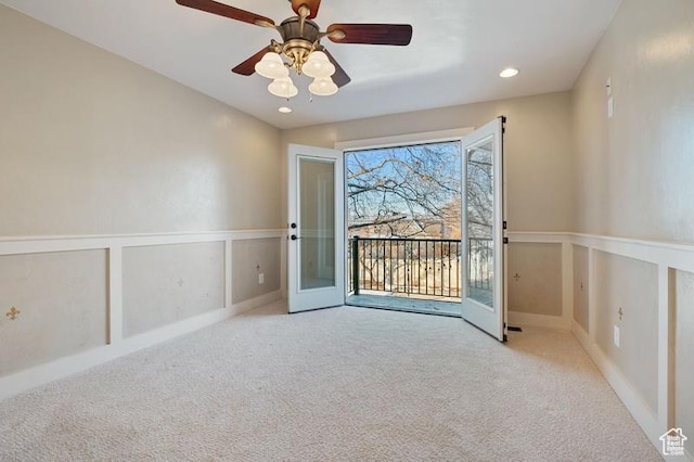 carpeted empty room featuring french doors and ceiling fan