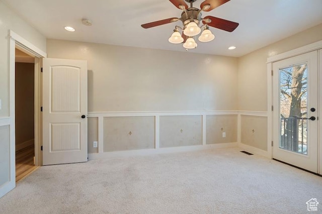 spare room featuring light colored carpet