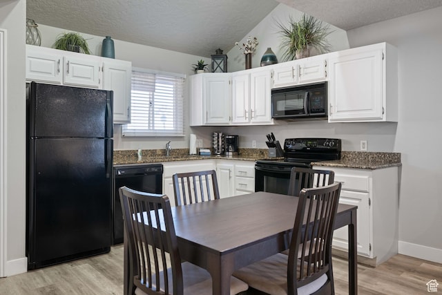 kitchen with a textured ceiling, light hardwood / wood-style flooring, black appliances, and white cabinets