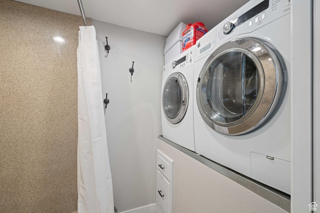 clothes washing area with washer and dryer