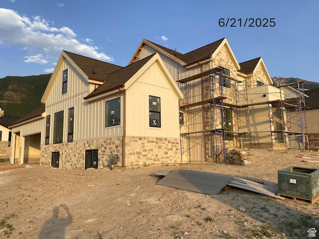 1299 S 1090 E, Salem, UT 84653 - view of side of property featuring stone siding, board and batten siding, a garage, and roof with shingles