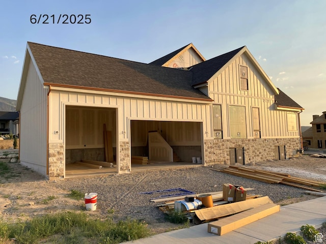 1299 S 1090 E, Salem, UT 84653 - view of home's exterior featuring board and batten siding, a garage, roof with shingles, and stone siding