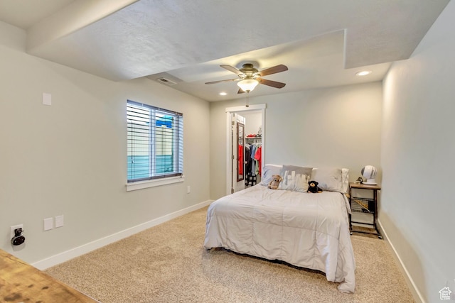 carpeted bedroom featuring recessed lighting, a walk in closet, baseboards, visible vents, and a ceiling fan