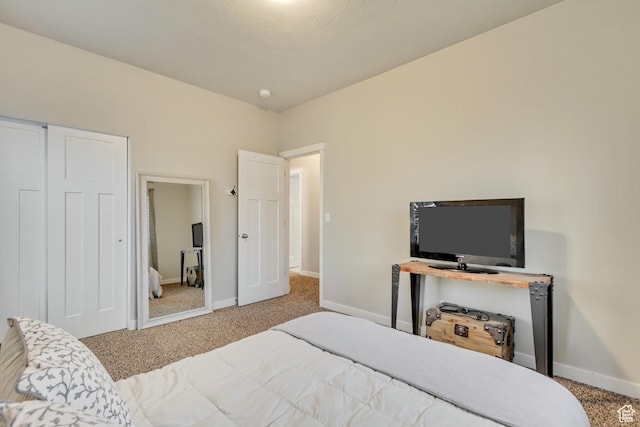 carpeted bedroom with baseboards