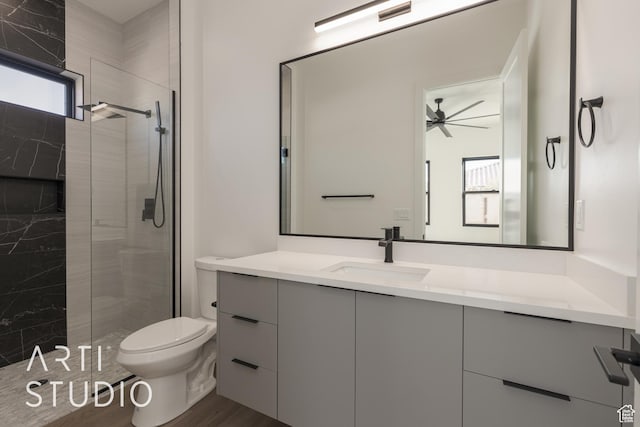 2752 S 3930 W, Hurricane, UT 84737 - bathroom featuring hardwood / wood-style floors, vanity, ceiling fan, toilet, and a shower with door