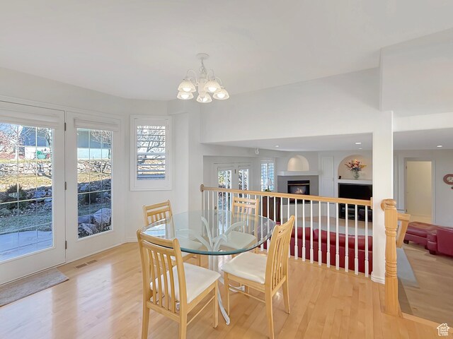 dining area featuring a chandelier and light wood-type flooring