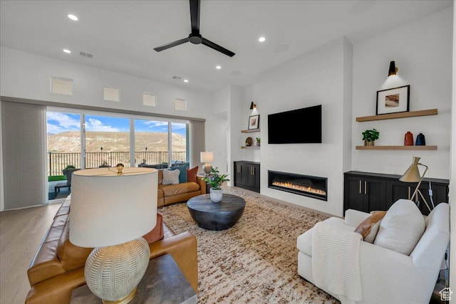 living room with hardwood / wood-style flooring and ceiling fan