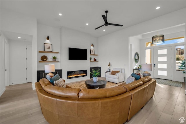 living room featuring light hardwood / wood-style flooring and ceiling fan