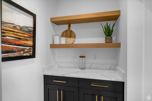 bar featuring light stone countertops