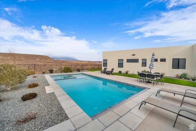 view of swimming pool featuring a mountain view and a patio area