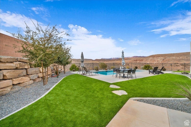 view of yard with a fenced in pool, a patio area, and a mountain view