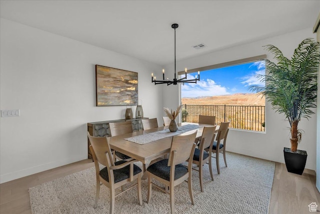 dining space featuring a chandelier and light hardwood / wood-style floors