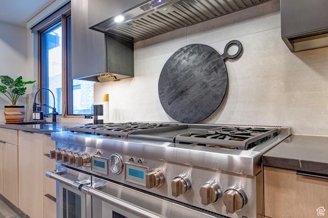 1271 Lowell Ave Unit B202, Park City, UT 84060 - kitchen featuring tasteful backsplash, sink, light brown cabinets, range with two ovens, and wall chimney range hood