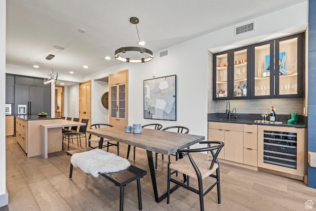1271 Lowell Ave Unit B202, Park City, UT 84060 - dining room featuring beverage cooler, light hardwood / wood-style flooring, and wet bar