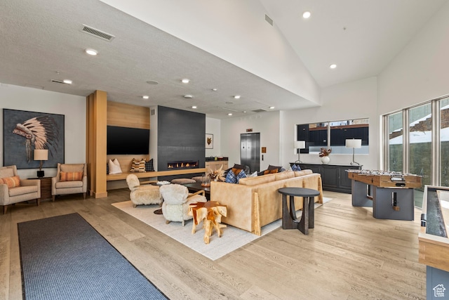 1271 Lowell Ave Unit B202, Park City, UT 84060 - living room with high vaulted ceiling, elevator, a textured ceiling, and light wood-type flooring