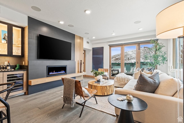 1271 Lowell Ave Unit B202, Park City, UT 84060 - living room with wine cooler, hardwood / wood-style flooring, a fireplace, and bar area
