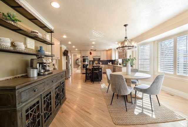 6658 S Caracol Cv, Cottonwood Heights, UT 84121 - dining area with recessed lighting, light wood-style flooring, a chandelier, baseboards, and crown molding