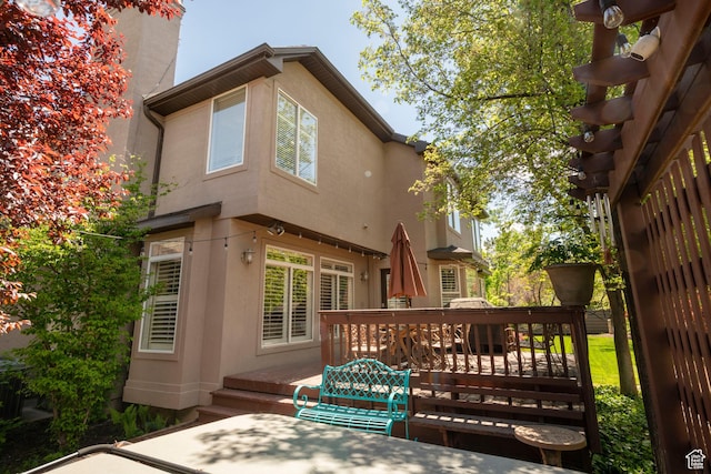 6658 S Caracol Cv, Cottonwood Heights, UT 84121 - rear view of property with stucco siding and a wooden deck