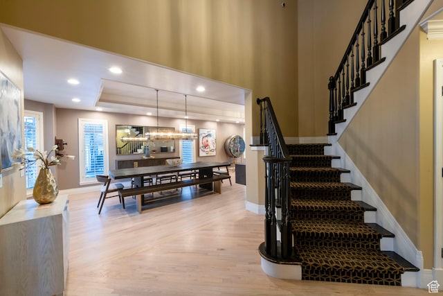 6658 S Caracol Cv, Cottonwood Heights, UT 84121 - staircase featuring wood finished floors, baseboards, a chandelier, a raised ceiling, and recessed lighting
