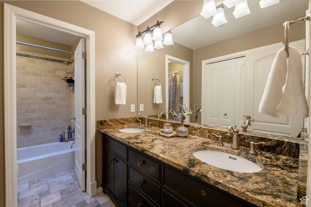 6658 S Caracol Cv, Cottonwood Heights, UT 84121 - bathroom featuring double vanity, stone finish floors, and shower / tub combination