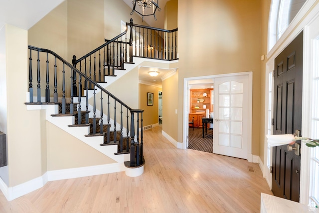 6658 S Caracol Cv, Cottonwood Heights, UT 84121 - entryway featuring baseboards, a high ceiling, wood finished floors, stairway, and a chandelier