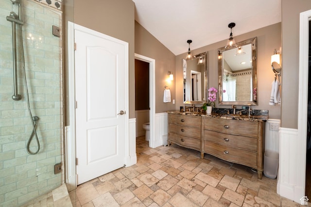 6658 S Caracol Cv, Cottonwood Heights, UT 84121 - full bath featuring stone tile flooring, a wainscoted wall, a stall shower, toilet, and double vanity