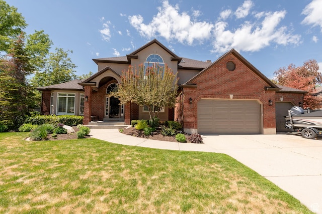 6658 S Caracol Cv, Cottonwood Heights, UT 84121 - view of front of house featuring an attached garage, a front lawn, driveway, and brick siding