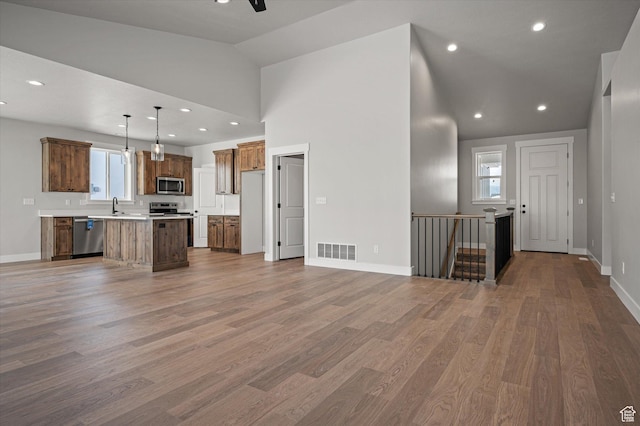 855 E 410 N Unit 157, Hyde Park, UT 84318 - unfurnished living room with wood-type flooring, high vaulted ceiling, sink, and ceiling fan