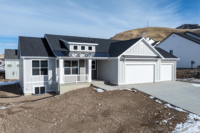 855 E 410 N Unit 157, Hyde Park, UT 84318 - view of front of house featuring a garage, central AC unit, and covered porch