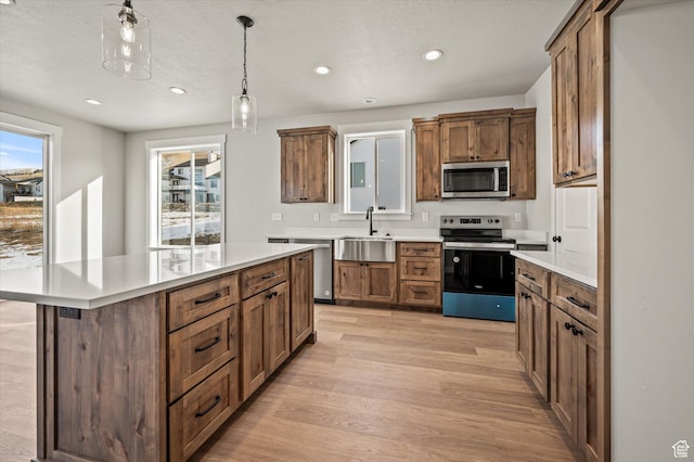 855 E 410 N Unit 157, Hyde Park, UT 84318 - kitchen with sink, appliances with stainless steel finishes, a center island, light hardwood / wood-style floors, and decorative light fixtures
