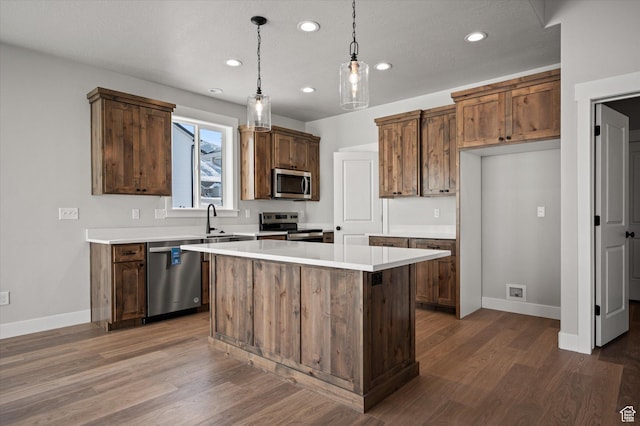 855 E 410 N Unit 157, Hyde Park, UT 84318 - kitchen with dark wood-type flooring, stainless steel appliances, hanging light fixtures, and a kitchen island