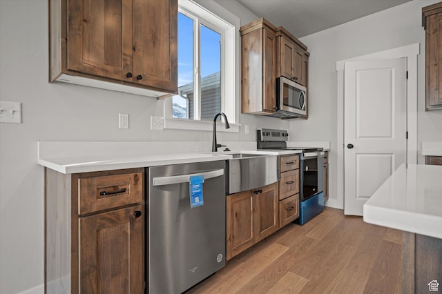 855 E 410 N Unit 157, Hyde Park, UT 84318 - kitchen featuring stainless steel appliances, sink, and light hardwood / wood-style flooring
