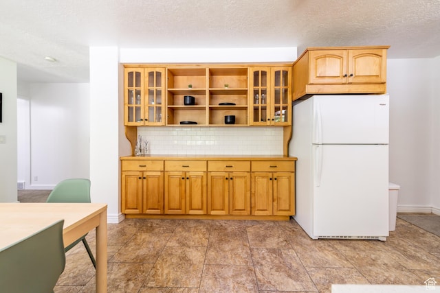 1097 E Thrushwood Dr, Logan, UT 84321 - kitchen featuring tasteful backsplash, a textured ceiling, and white fridge