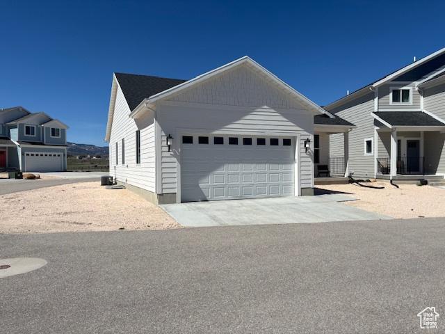 133 E Sailors Way, Garden City, UT 84028 - view of front of house with central AC unit, driveway, and a garage