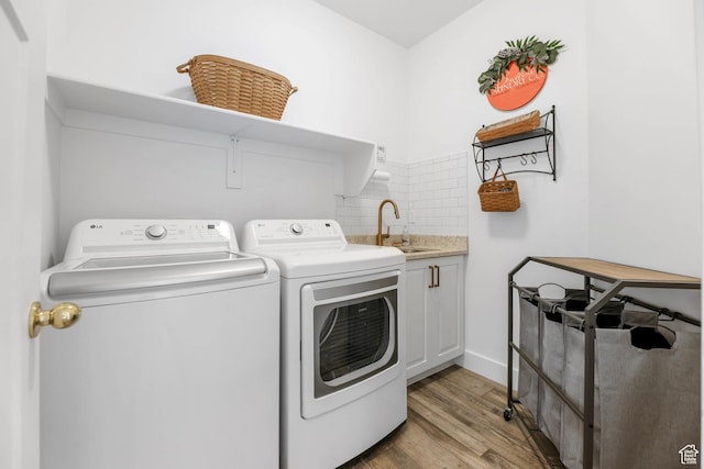 3932 W 2875 N, Plain City, UT 84404 - washroom with washer and dryer, cabinet space, and light wood finished floors
